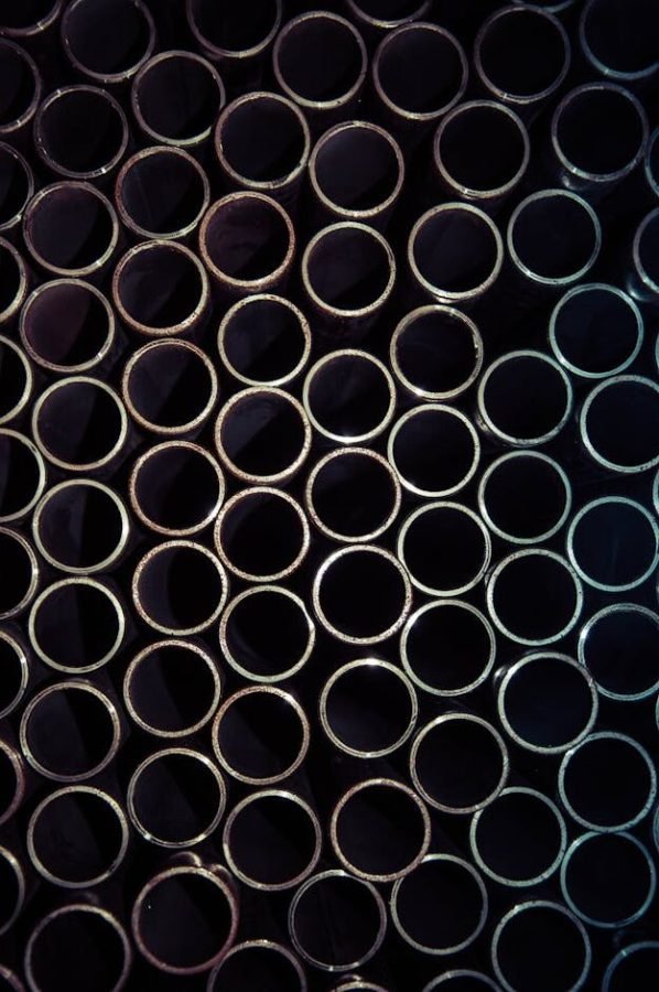 pexels-photo-1381938-1381938 A detailed macro shot of stacked metal tubes forming a circular pattern, highlighting industrial design.